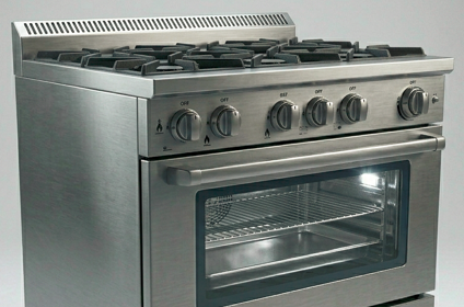 Engineer repairing a commercial gas range